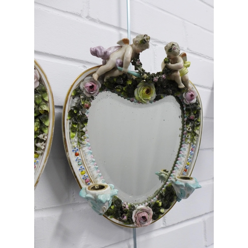 410 - Pair of continental porcelain wall mirrors / candle sconces, heart shaped with cherubs and floral en... 