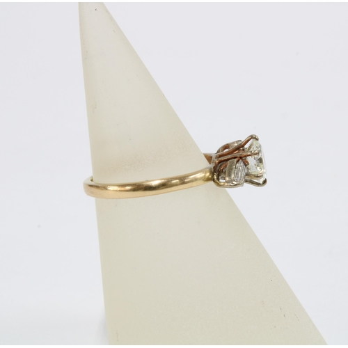 79 - Diamond ring with a claw set diamond flanked by baguette gems, possibly moissanites, on an unmarked ... 