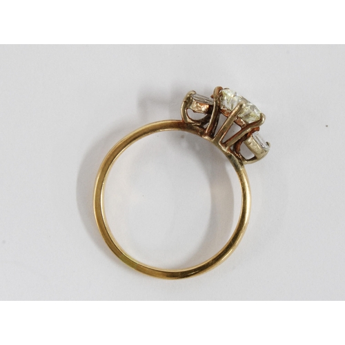 79 - Diamond ring with a claw set diamond flanked by baguette gems, possibly moissanites, on an unmarked ... 