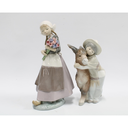 98 - Lladro figures ‘Platero and Marcelino’ No.1180 and another of a girl with flowers, taller 25cm (2)