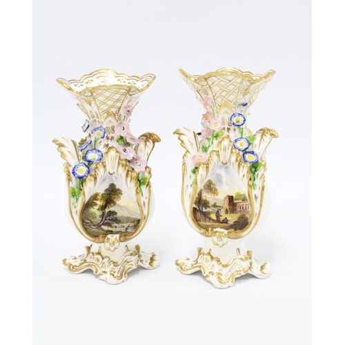 104 - Pair of 19th century rococo style vases, floral encrusted with painted landscape scenes, each with a... 