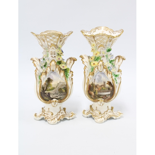 104 - Pair of 19th century rococo style vases, floral encrusted with painted landscape scenes, each with a... 