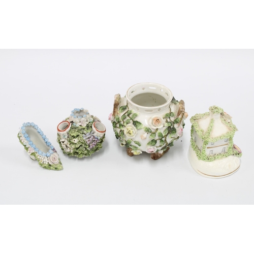 105 - Collection of small floral encrusted porcelain, to include a cottage, shoe and cauldron, etc, talles... 