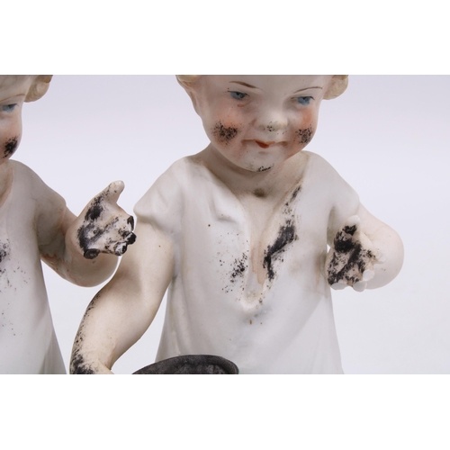 116 - Three bisque figures of children covered in ink, the two standing both a/f, 16cm (3)