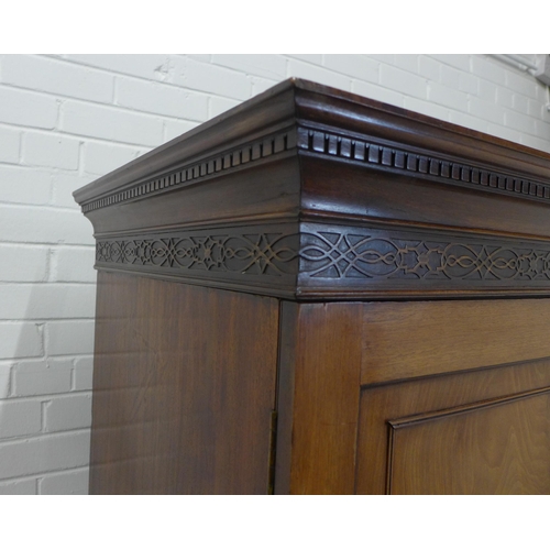 210 - Georgian flame mahogany linen press, the cornice with dentil frieze over blind fret carving and a pa... 