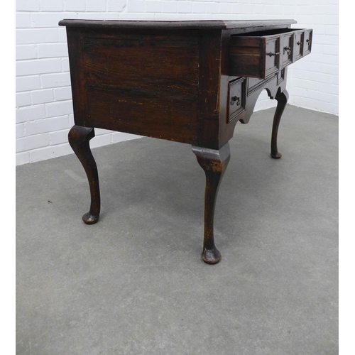 212 - An oak lowboy, rectangular top over an arrangement of six drawers, on cabriole legs, 102 x 74 x 55cm... 