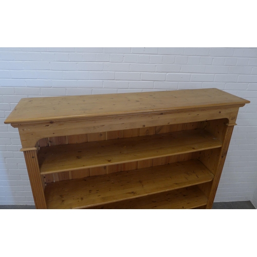 230 - Pine open bookcase with panelled back and two short drawers, 150 x 151 x 36cm.