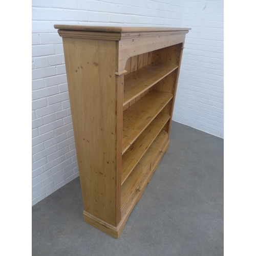 230 - Pine open bookcase with panelled back and two short drawers, 150 x 151 x 36cm.