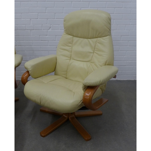 243 - Pair of Stressless  style cream leather armchairs and footstools, 80 x 100 x 50cm. (4)