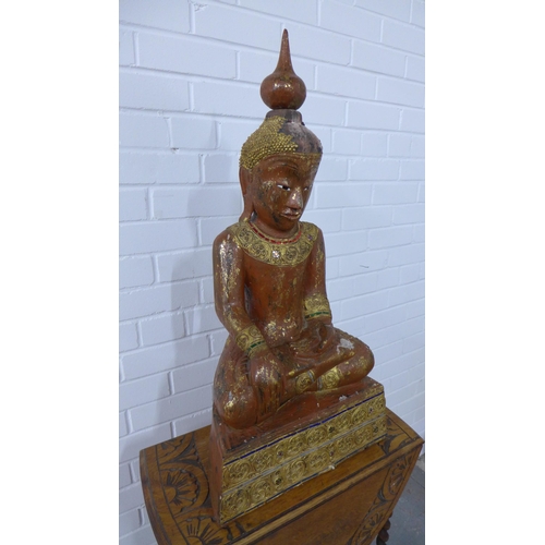 265 - Painted giltwood Buddha together with an oak gateleg table (2) ,