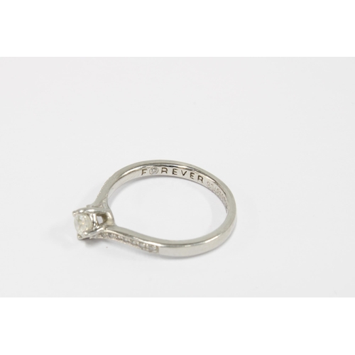 32 - Forever platinum diamond ring with a claw set brilliant diamond, approx 0.25ct, with smaller diamond... 