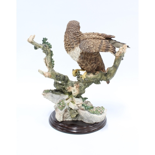 328 - A Country Artists sculpture of  a Buzzard, on a circular wooden base, 26cm high