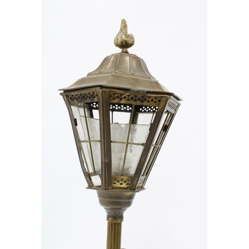 329 - Brass figural table lamp base with a boy standing beneath a lamp post with glass panelled lantern sh... 