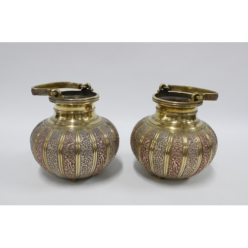 342 - A pair of brass bowls with swing handles and mixed metal pattern in relief,  16cm high excluding han... 