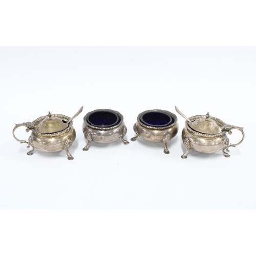 5 - Four piece silver cruet set, Chester 1911, comprising two salts and two mustards, with blue glass li... 