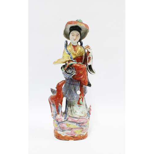 75 - Chinese polychrome enamelled female figure with deer and a basket of flowers, 37cm