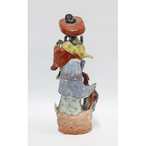 75 - Chinese polychrome enamelled female figure with deer and a basket of flowers, 37cm