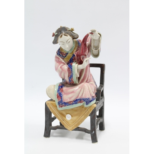 76 - Chinese polychrome enamelled female figure, seated on a chair, 23cm