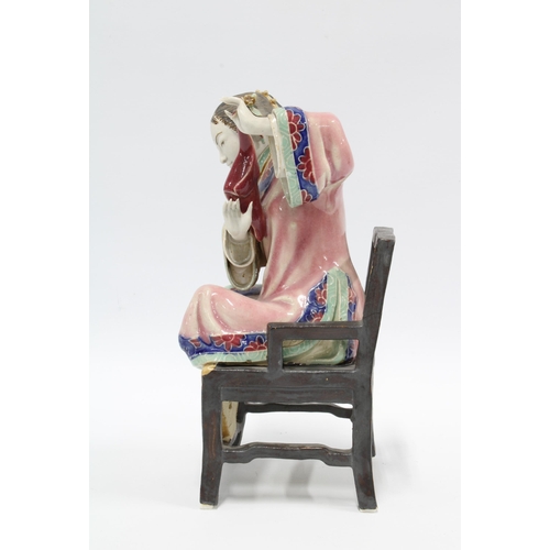 76 - Chinese polychrome enamelled female figure, seated on a chair, 23cm