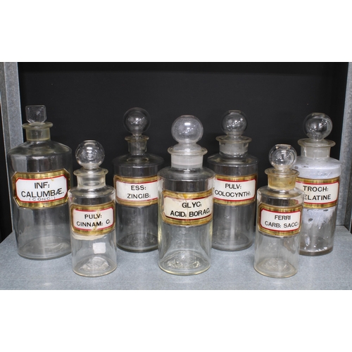 84 - Collection of seven clear glass apothecary / pharmacy bottles and stoppers with gilt Latin contents ... 