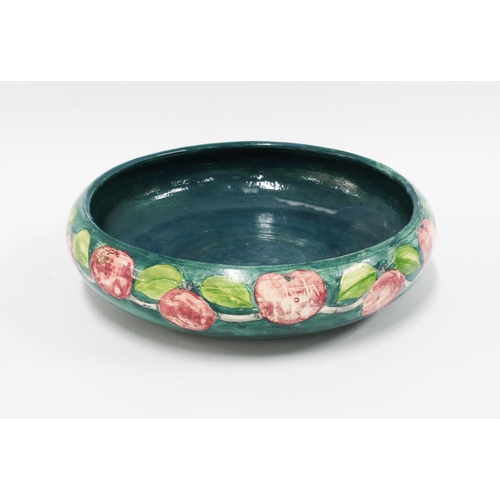 94 - Holyrood Pottery, early 20th century shallow bowl, green ground decorated with plums, impressed back... 