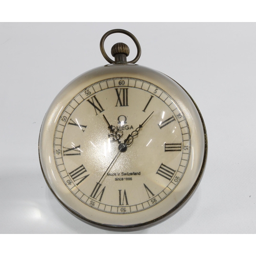 403 - Omega glass ball clock with roman numerals and brass loop