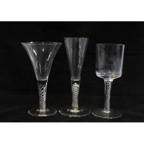 423 - An 18th century enamel twist wine glass and two later air twist stemmed glasses, (3) 18cm