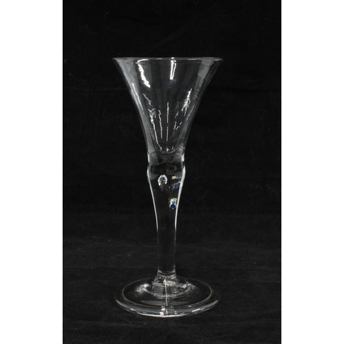 424 - An 18th century wine glass with tear drop to the stem, 16cm high