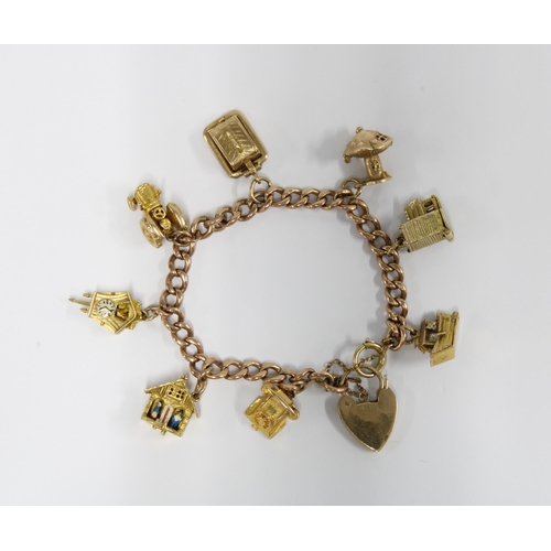 65 - 9ct gold charm bracelet with a heart shaped pendant, with eight charms - six stamped 9ct