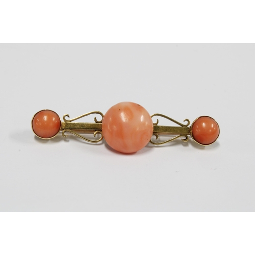 69 - A coral brooch set in unmarked yellow metal, 5.5cm long