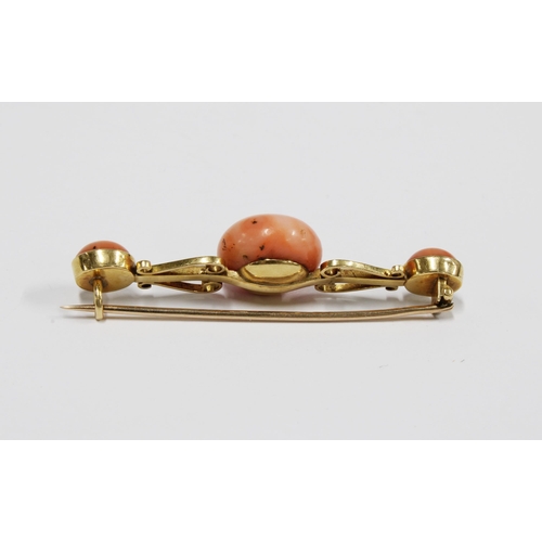 69 - A coral brooch set in unmarked yellow metal, 5.5cm long