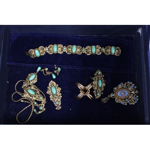 76A - A blue leather jewellery box containing an 18ct coral ring (one stone lacking), two yellow metal gem... 