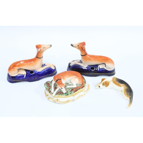 82 - A pair of Victorian Staffordshire greyhound pen holders, 9cm tall, together with another greyhound a... 