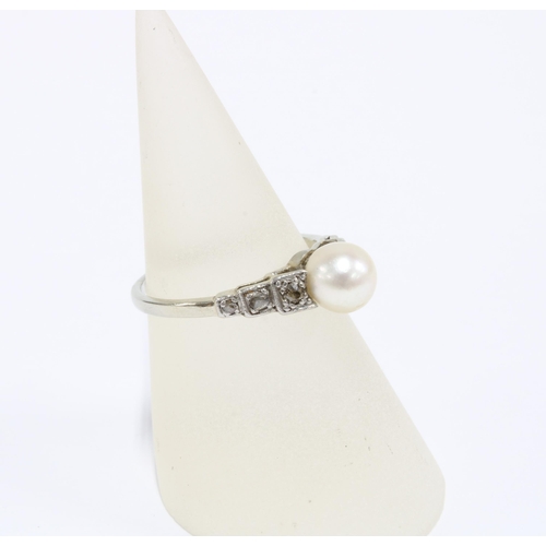 15 - An Edwardian pearl and diamond ring, set in a platinum and white metal ring