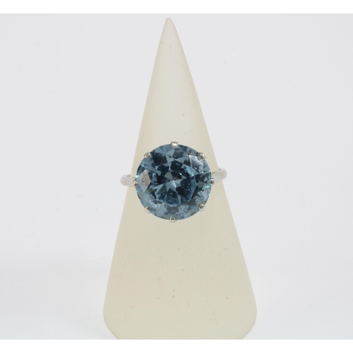 22 - A platinum dress ring, claw set with a single pale blue spinel together with a pair of spinel drop e... 