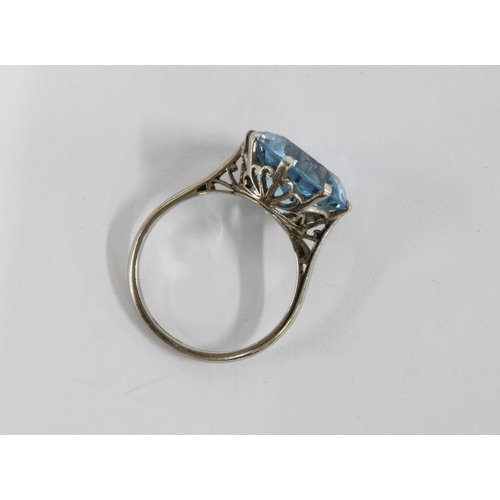 22 - A platinum dress ring, claw set with a single pale blue spinel together with a pair of spinel drop e... 