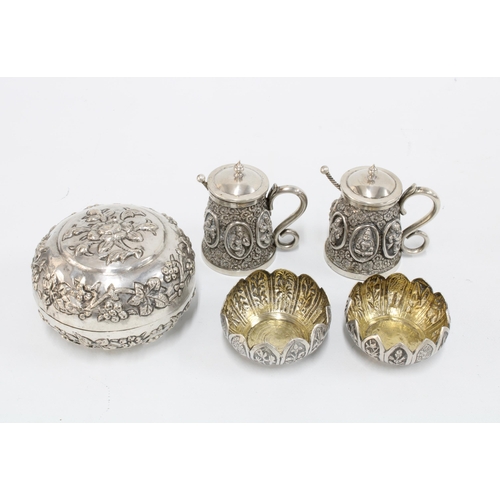 38 - A pair of Indian white metal condiments of tankard form with rupee coin salt spoons together with a ... 