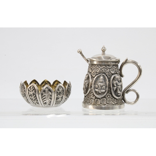38 - A pair of Indian white metal condiments of tankard form with rupee coin salt spoons together with a ... 