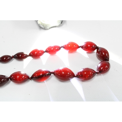 58 - A strand of graduating cherry amber beads, together with a graduating strand of butterscotch amber b... 