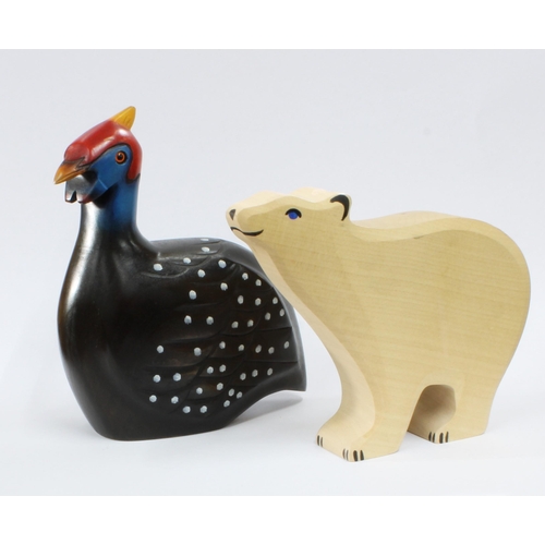 461 - Holztiger wooden polar bear with blue painted eyes together with an African Carvers painted wood Gui... 