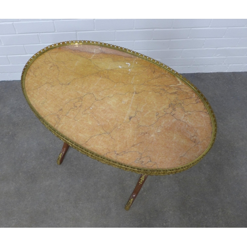 203 - Brass mounted mahogany table with an oval red hardstone top with brass gallery,  75 x 56 x 47cm.