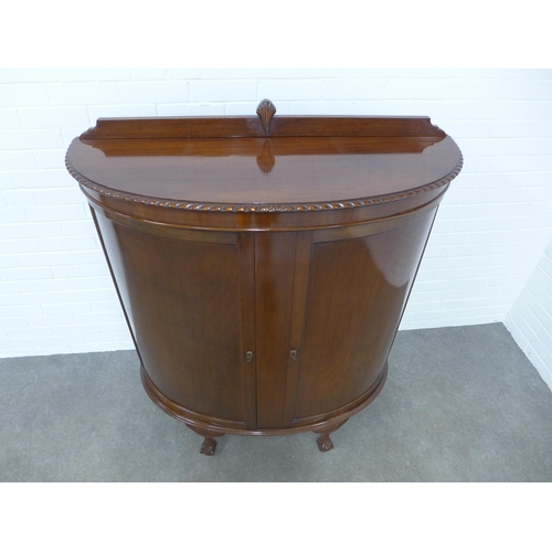 208 - Mahogany bow front cabinet, the shaped top with gadrooned edge over two plain doors, opening to reve... 