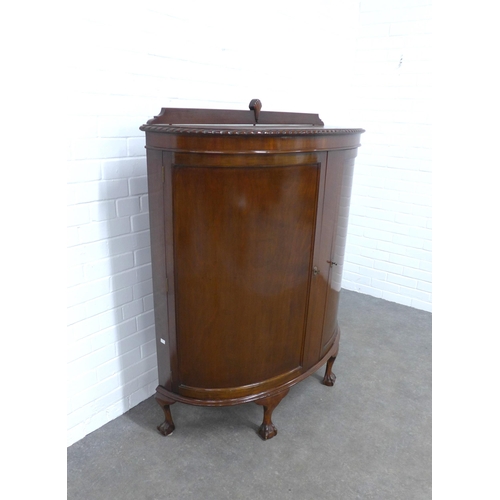 208 - Mahogany bow front cabinet, the shaped top with gadrooned edge over two plain doors, opening to reve... 