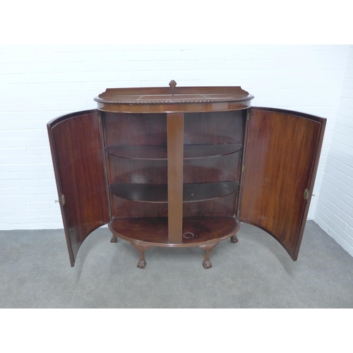 208 - Mahogany bow front cabinet, the shaped top with gadrooned edge over two plain doors, opening to reve... 