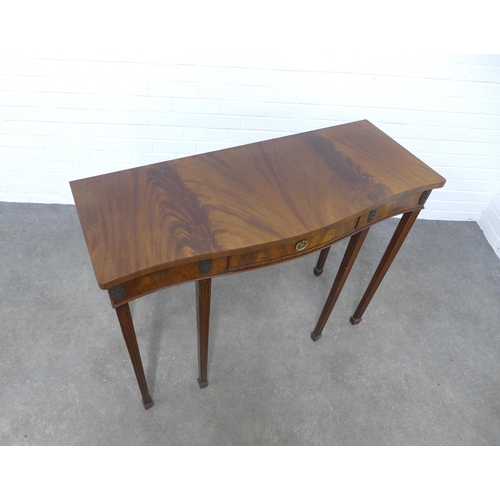 214 - Mahogany serpentine consol table on tapering legs and spade feet, 107 x 83 x 43cm.