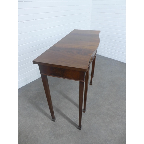 214 - Mahogany serpentine consol table on tapering legs and spade feet, 107 x 83 x 43cm.