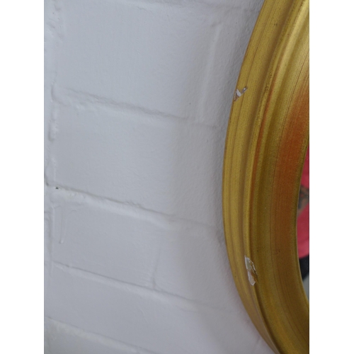 216 - Circular gilt framed oval wall mirror, 39 x 48cm.