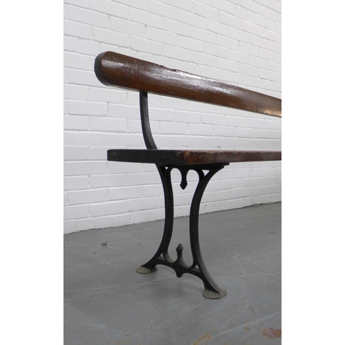 222 - Early 20th century stained pine pew / bench with black iron supports, 330 x 73 x 28cm