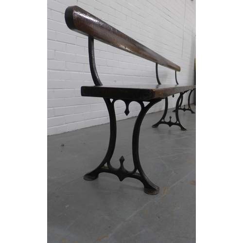 223 - Early 20th century stained pine pew / bench with black iron supports, 330 x 73 x 28cm