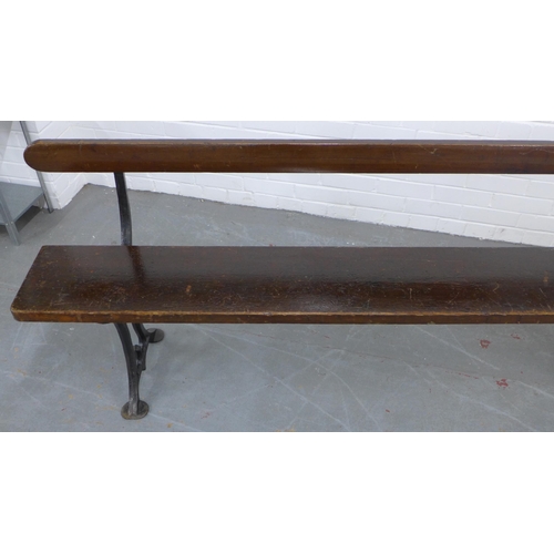 224 - Early 20th century stained pine pew / bench with black iron supports, 330 x 73 x 28cm